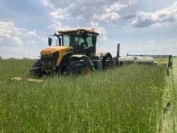 FILE - Farmer Dave Gruenbaum plants corn as he terminates off-season cover crops with a roller near Plain City, Ohio, May 2021. (Dave Gruenbaum/Handout via Reuters)