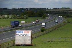 A sign reading "Boris Stop Huawei" is seen next to the M40 motorway, Tetsworth, Britain, May 1, 2020.
