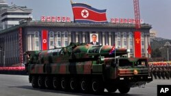 A line of Japan Ground Self-Defense Force tanks flare up a smoke screen during an annual live firing exercise at Higashi Fuji training range in Gotemba, southwest of Tokyo.