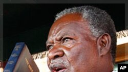 Zambia's new President Michael Sata, right, takes the oath of office on the steps of the supreme court in Lusaka, Zambia, Friday Sept. 23, 2011. 