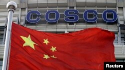 A Chinese national flag flies in front of COSCO's headquarters in Beijing Aug. 26, 2010. 