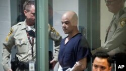 FILE - Robert Telles, a former county administrator of estates in Nevada, is escorted into court on Sept. 8, 2022, in Las Vegas. He is accused of killing investigative journalist Jeff German in 2022 after German wrote articles that were critical of him.