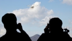 People take pictures of the "Volocopter 2X" drone taxi during an Urban Air Mobility Airport Demo event at Gimpo Airport in Seoul, South Korea, November 11, 2021. (REUTERS/Heo Ran)