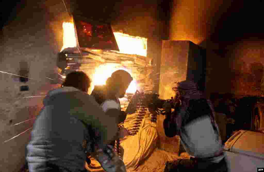 Rebel fighters from the Free Syrian Army fire a heavy machine gun during fighting against government forces&nbsp; in the Salah al-Din neighbourhood of the northern Syrian city of Aleppo.