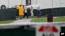 Migrant children walk on the grounds of the Homestead Temporary Shelter for Unaccompanied Children, June 16, 2019, in Homestead, Florida. 