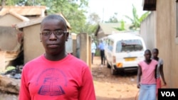 Phiona Mutesi stands near where she grew up in Katwe slum, Kampala, Uganda, January 28, 2012. (H. Heuler/VOA)
