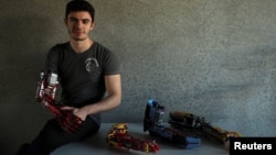 David Aguilar poses with his prosthetic arms built with Lego pices during an interview with Reuters in Sant Cugat del Valles, near Barcelona, Spain, on February 4, 2019. (Reuters/Albert Gea)