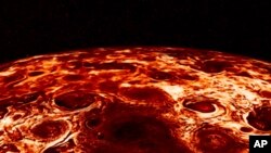 This composite image provided by NASA, derived from data collected by the Jupiter-orbiting Juno spacecraft, shows the central cyclone at the planet's north pole and the eight cyclones that encircle it. (NASA/JPL-Caltech/SwRI/ASI/INAF/JIRAM via AP)