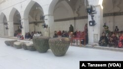 Drummers beat large drums called naubat every evening at sunset while people perform a devotional dance called dhamaal in Sindh, Pakistan.