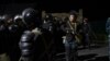 Police block the road toward Kyrgyzstan's ex-president Almazbek Atambayev's residence in the village of Koi-Tash, about 20 kilometers (12 miles) south of the capital, Bishkek, Kyrgyzstan, Aug. 7, 2019.