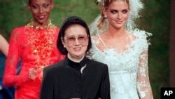 FILE - Japanese fashion designer Hanae Mori, center, is applauded by models after the presentation of her 1997-98 fall-winter collection presented in Paris, July 9, 1997.