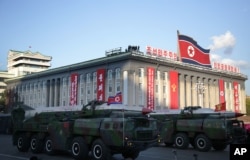 FILE - Medium-range Nodong missiles are paraded in Pyongyang, North Korea, Oct. 10, 2015. Tokyo is concerned that any deal that could be struck between the U.S. and North Korea, could leave Japan vulnerable to a North Korean attack with medium range missiles, such as the Nodong.