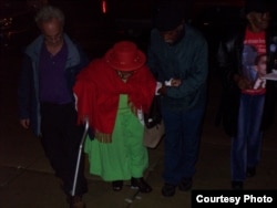 Bakary Tandia and his team of grassroots volunteers help an elderly African American woman get to the polls to vote, in Philadelphia, Pennsylvania, on Election Day 2008. (Credit: Bakary Tandia)