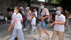 Tourists wear face masks as they visit the Summer Palace in Beijing Tuesday, Aug. 3, 2021. (AP Photo/Ng Han Guan)