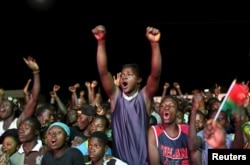 Supporters of President-elect Roch Marc Kaboré cheer at his campaign headquarters in Ouagadougou, Burkina Faso, Dec. 1, 2015.