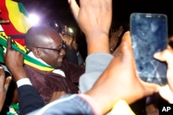 Pastor Evan Mawarire leaves the Harare Magistrates Court, Zimbabwe, July 13, 2016, after the court freed him ruling that police violated his rights.