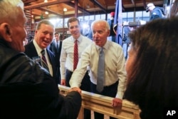FILE - Conor Lamb, left center, the Democratic candidate for the March 13 special election in Pennsylvania's 18th Congress and former Vice President Joe Biden, center, work a crowd of supporters during a rally at the Carpenter's Training Center in Collier, Pennsylvania.