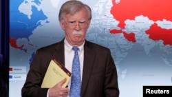FILE - U.S. National Security Adviser John Bolton arrives to address reporters as the Trump administration announces economic sanctions against Venezuela during a press briefing at the White House in Washington, Jan. 28, 2019.
