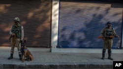 Paramilitary soldiers stand guard on a deserted street on the first anniversary of India’s decision to revoke the disputed region’s semi-autonomy, in Srinagar, Indian controlled Kashmir, Aug. 5, 2020.
