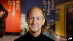 Protesters walk through a road in Yangon, Myanmar, with umbrellas bearing the number 8 in Burmese during a rally to mark the anniversary of the August 8, 1988 democracy uprising. 
