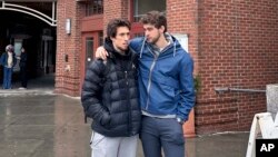 Basketball players Romeo Myrthil, left, and Cade Haskins talk after voting at Dartmouth College in Hanover, New Hampshire, on March 5, 2024, on whether to form a union.