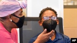 Latosha Wilson comforts her son Kerington Wilson, 9, after he received the Pfizer-BioNTech COVID-19 vaccine for children 5 to 12 years old at a vaccination site in Fort Worth, Texas, Nov. 11, 2021.