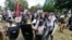 "Alt-right" demonstrators clash with counter-demonstrators at the entrance to Lee Park in Charlottesville, Va., Aug. 12, 2017.