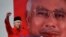 FILE - Malaysian Prime Minister Najib Razak addresses delegates during his speech at the Malaysia's ruling party United Malays National Organization's (UMNO) anniversary celebration.
