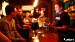 FILE - Glasses of alcoholic beverages are pictured in a craft beer bar in Kazan, Russia.