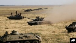 Ukrainian tanks and APCs move towards the de-facto border with Crimea near Kherson, southern Ukraine, Friday, Aug. 12, 2016.