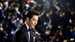 FILE - In this Friday, Nov. 21, 2014 file photo, South Korean actor Kim Woo-bin arrives for a photo call during the Daejong Film Awards in Seoul, South Korea. Chinese anger at South Korea over its decision to deploy an U.S. anti-missile defense system appears to be threatening everything from appearances by the stars of K-Pop to future cooperation on North Korea at the United Nations. 