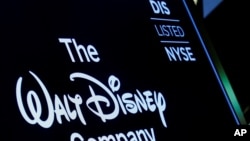 FILE PHOTO: A screen shows the logo and a ticker symbol for The Walt Disney Company on the floor of the New York Stock Exchange in New York, Dec. 14, 2017.