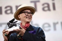 Director and writer Yonfan, holds the award for Best Screenplay for the film 'No. 7 Cherry Lane at the closing ceremony of the 76th edition of the Venice Film Festival, Venice, Italy, Saturday, Sept. 7, 2019. (Photo by Joel C Ryan/Invision/AP)