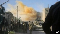 FILE - Smoke rises after an airstrike by a U.S.-led coalition warplane as Iraqi security forces advance their position during heavy fighting against Islamic State militants in Fallujah, Iraq, June 14, 2016.
