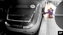 FILE — In this image from surveillance video aired by Iranian state television, women pull 16-year-old Armita Geravand from a train car on the Tehran Metro in Tehran, Iran, on Oct. 1, 2023.