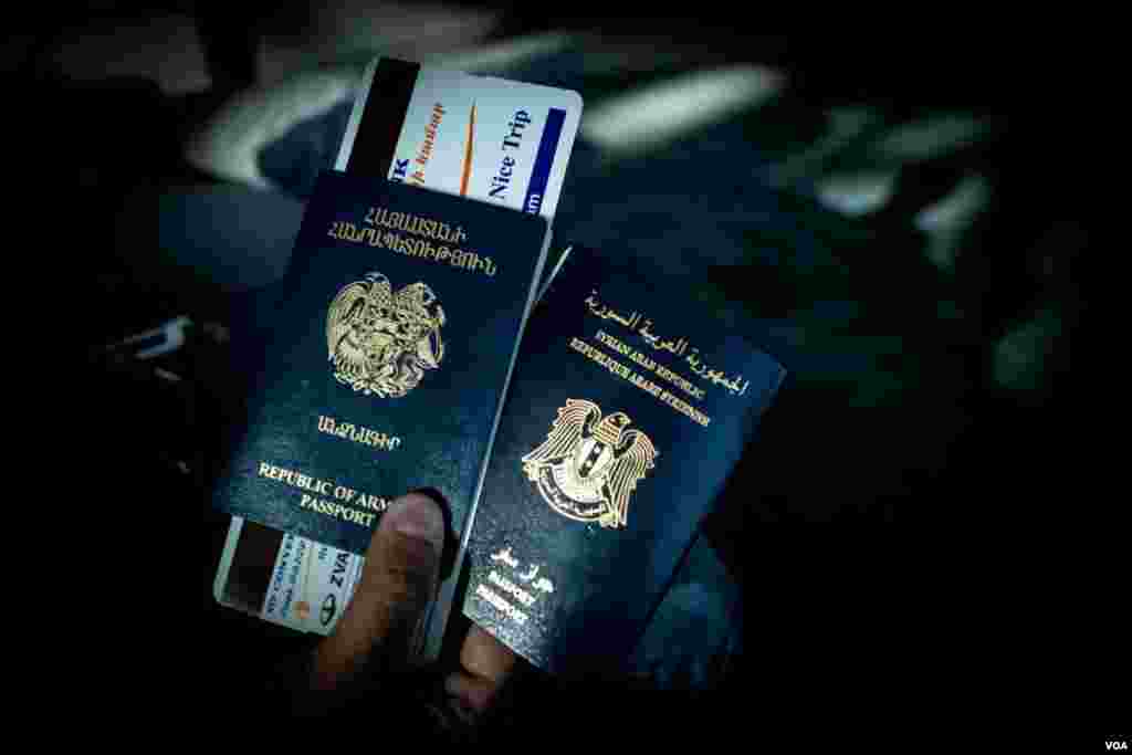 A Syrian-Armenian national holds his Syrian and Armenian passports at the Zvartnots Airport, December 2012. (VOA/D. Markosian)