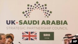 FILE - Saudi Crown Prince Mohammed bin Salman, 2nd right, conducts a meeting with then-Britain's Prime Minister Theresa May, 2nd left, with other members of their delegations, inside 10 Downing Street, London, March 7, 2018.