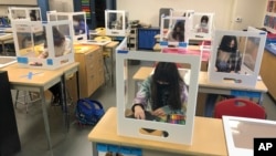 In this March 2, 2021, file photo, socially distanced and with protective partitions students work on an art project during class at the Sinaloa Middle School in Novato, Calif. (AP Photo/Haven Daley, File) 