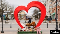 A man walks past a makeshift memorial for the victims of the deadly shelling on December 30, 2023, in the center of Belgorod, Russia, on March 10, 2024.