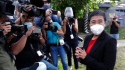 FILE - Rappler CEO Maria Ressa stands in front of reporters outside the Court of Tax Appeals in Manila, Philippines, March 4, 2021.