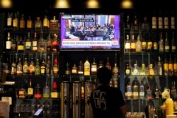 The U.S. Senate impeachment trial of President Donald Trump plays on a television at Malo restaurant in Des Moines, Iowa, Jan. 31, 2020.