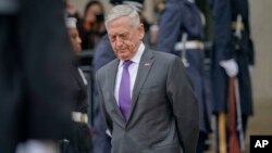FILE - Defense Secretary Jim Mattis waits outside the Pentagon, Nov. 9, 2018. 