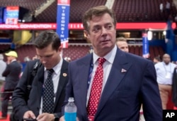 FILE - Trump campaign chairman Paul Manafort walks around the convention floor before the opening session of the Republican National Convention in Cleveland.