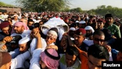 FILE - Mourners carry the body of one of the three policemen who were killed, March 3, 2015, by a remotely detonated bomb in the village of Daih. Two Bahrainis and one Emirati made up the three dead officers.