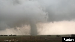 FILE - A tornado spins during stormy weather in Mangum, Okla., May 20, 2019 in this still image taken from a video from social media. (Lorraine Matti via REUTERS)