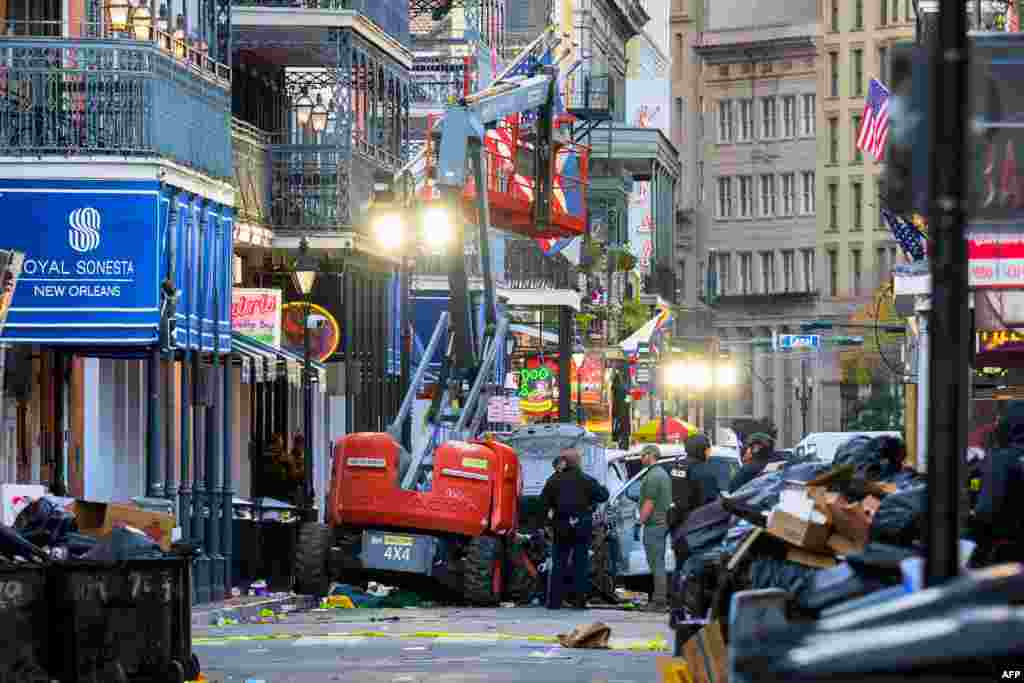 Police investigators surround a white truck that has been crashed into a work lift in the French Quarter of New Orleans, Louisiana, Jan. 1, 2025.