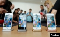 FILE - The new iPhone SE is seen on display during an event at the Apple headquarters in Cupertino, California, March 21, 2016.