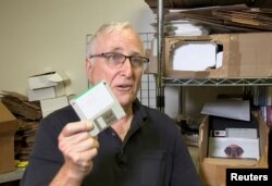 Tom Persky, the owner of floppydisk.com and disk trader, shows off a computer disk at his warehouse in Lake Forest, California, U.S., October 6, 2022 in this screengrab from a Reuters TV video. (REUTERS/Alan Devall)