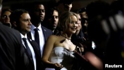 Cast member Jennifer Lawrence poses with fans at the premiere of "Passengers" in Los Angeles, California, Dec. 14, 2016. 