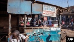 FILE - A butcher cuts meat at his shop on the streets of an open-air market on the outskirts of Lilongwe, Malawi, May 18, 2019. The government is looking to implement a 21-day coronavirus lockdown, which would close the country's large markets.
